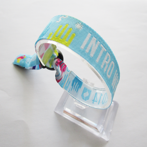 woven wristband with reusable plastic spring accessory