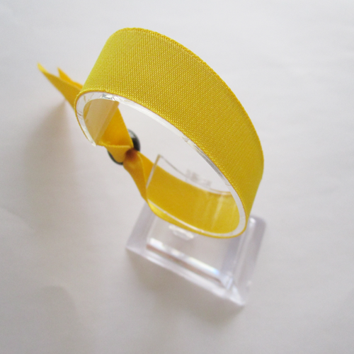 woven wristband with reusable plastic bead