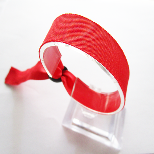 woven wristband with one time use plastic round slid closure