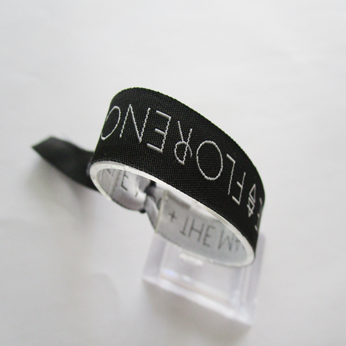 woven wristband with one time use plastic oval slid closure