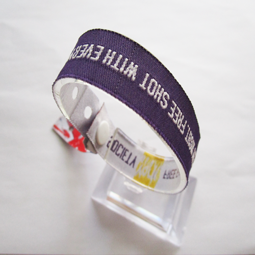 woven wristband with one time use PVC button